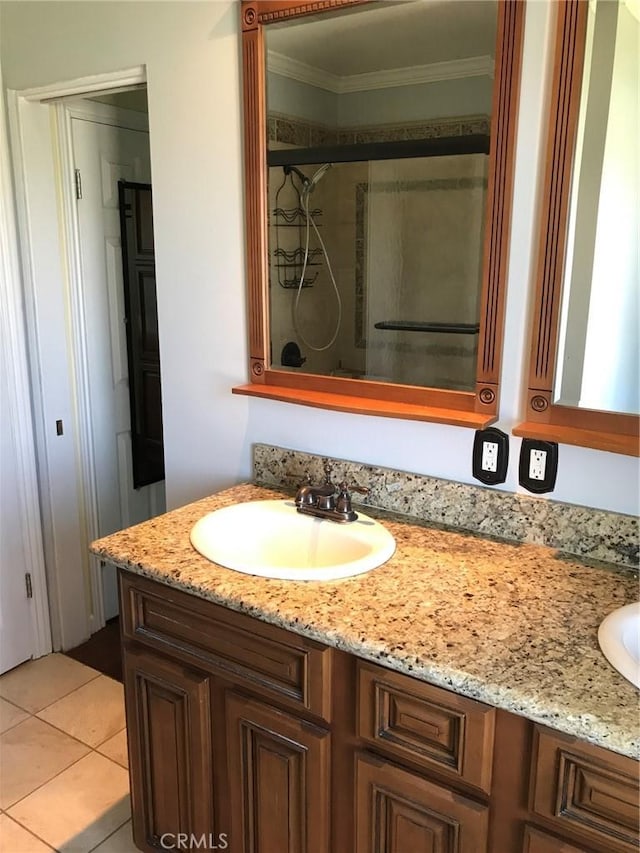 bathroom featuring vanity, a shower stall, tile patterned floors, and ornamental molding