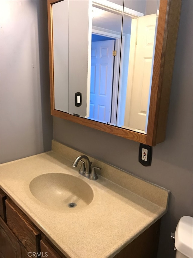 half bathroom featuring toilet and vanity