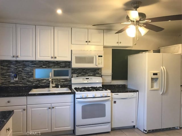 kitchen with backsplash, ceiling fan, white cabinets, white appliances, and a sink