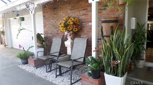 exterior space with a garage and brick siding