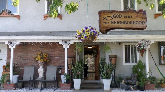 entrance to property with brick siding and stucco siding