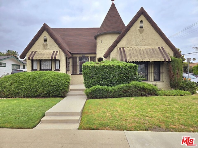 tudor house featuring a front yard