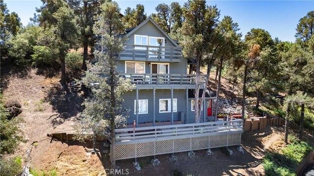 rear view of house featuring a deck