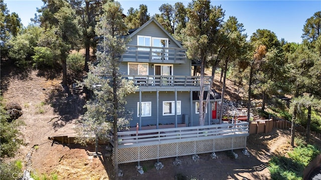 back of house featuring a wooden deck