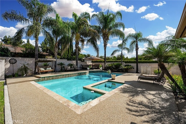 view of swimming pool with an in ground hot tub and a patio area