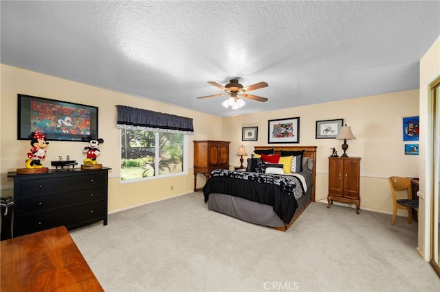 carpeted bedroom featuring a textured ceiling and ceiling fan