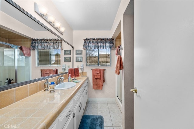 bathroom featuring vanity, a shower with shower door, and tile patterned floors