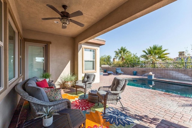 view of patio featuring a fenced in pool, ceiling fan, and an outdoor hangout area