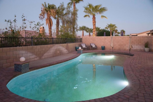 view of pool at dusk