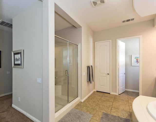 bathroom with tile patterned flooring, vanity, and walk in shower