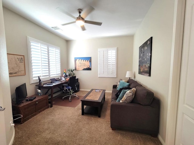 carpeted office space featuring ceiling fan