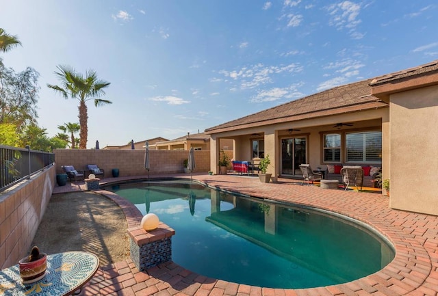 view of pool featuring a patio area, ceiling fan, and an outdoor living space