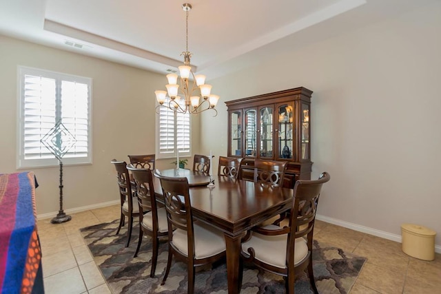 dining area featuring a chandelier, light tile patterned floors, and plenty of natural light