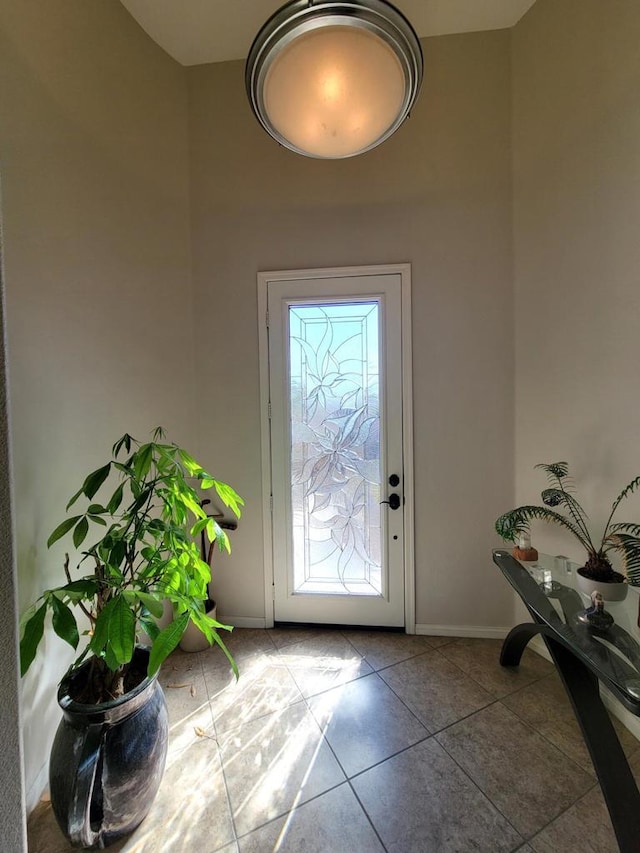 doorway with tile patterned flooring and plenty of natural light