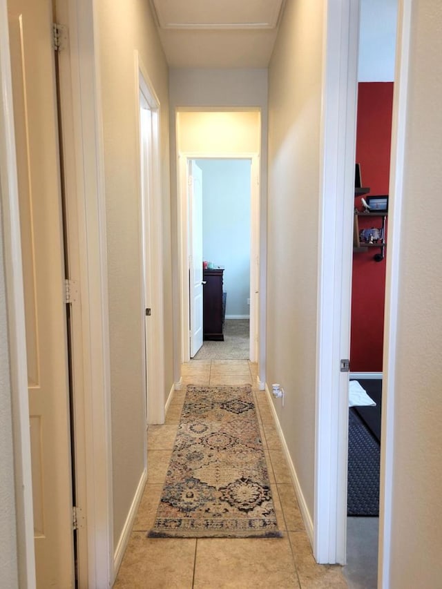 corridor featuring light tile patterned floors