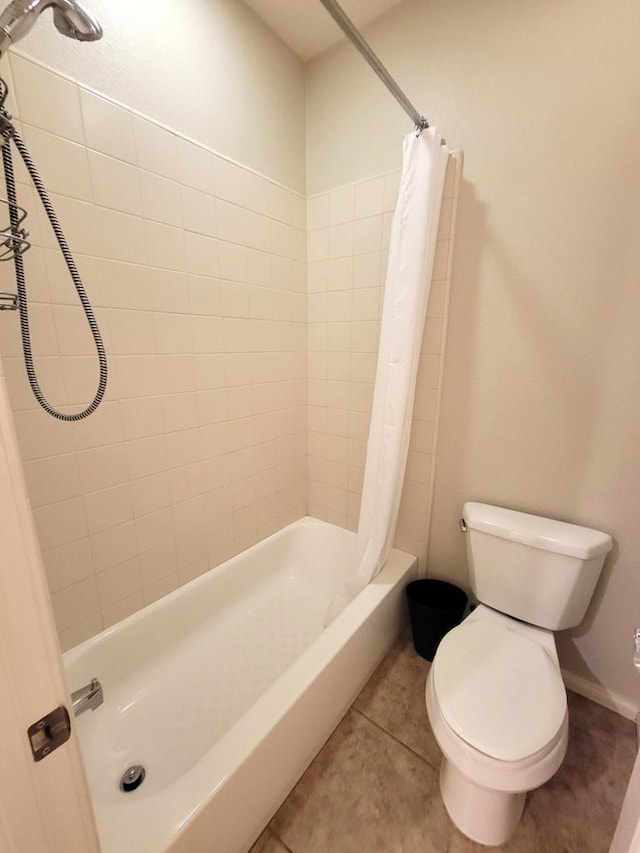 bathroom with tile patterned floors, toilet, and shower / bath combo with shower curtain