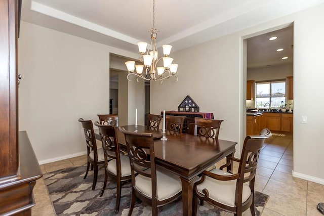 tiled dining area featuring a chandelier and sink