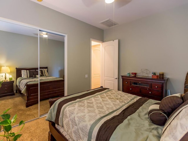 carpeted bedroom featuring a closet and ceiling fan