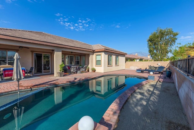 view of pool with a patio and ceiling fan