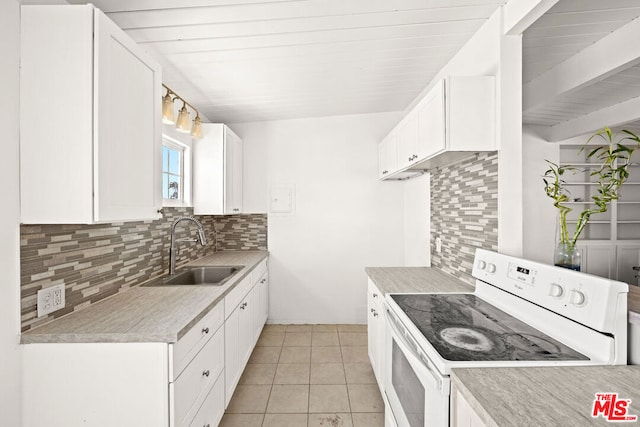 kitchen with decorative backsplash, white cabinets, white range with electric stovetop, and sink