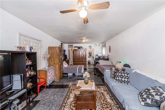 living room with ceiling fan and dark wood-type flooring