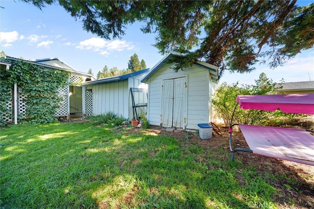 view of outbuilding with a lawn