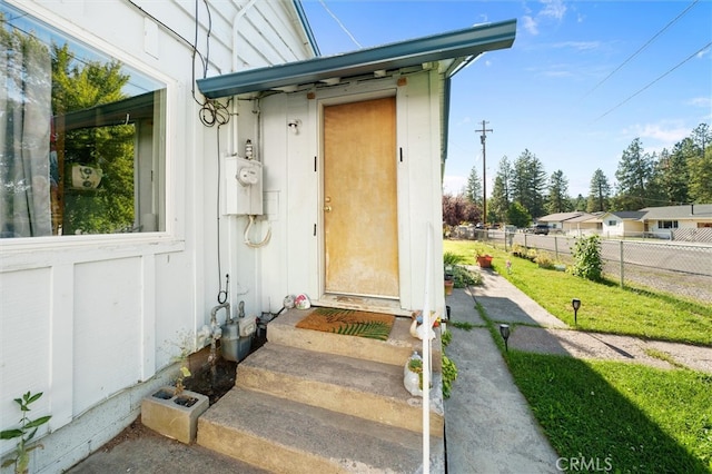 doorway to property with a yard