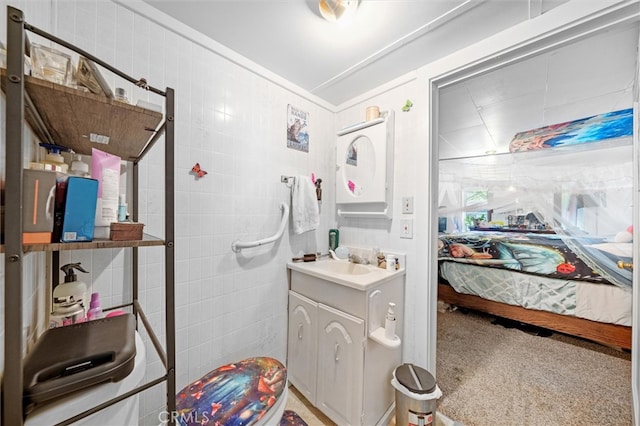 bathroom with tile walls and vanity