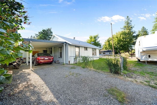 view of side of home with a carport