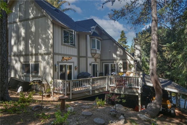 rear view of property featuring a deck