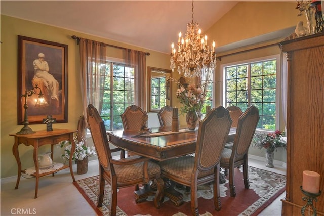 dining space featuring a chandelier and vaulted ceiling