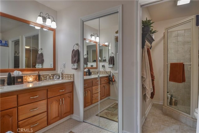 bathroom with a shower with door and vanity