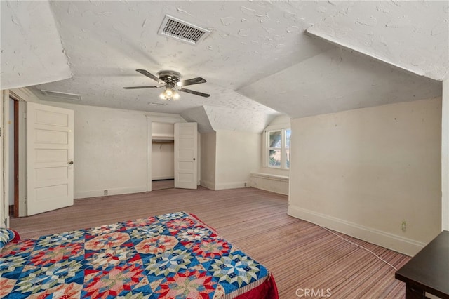 bonus room with ceiling fan, a textured ceiling, and vaulted ceiling