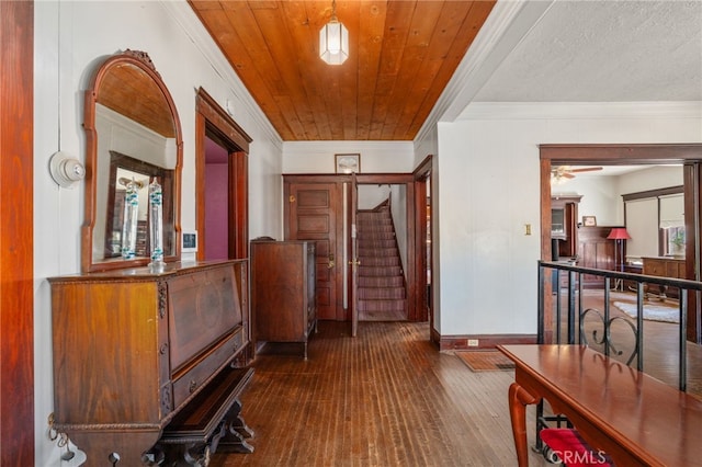 interior space featuring crown molding, dark hardwood / wood-style flooring, wood ceiling, and ceiling fan