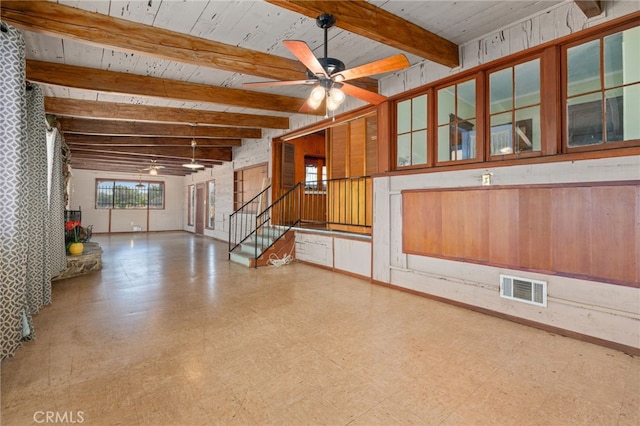 interior space with ceiling fan, wood ceiling, and beamed ceiling