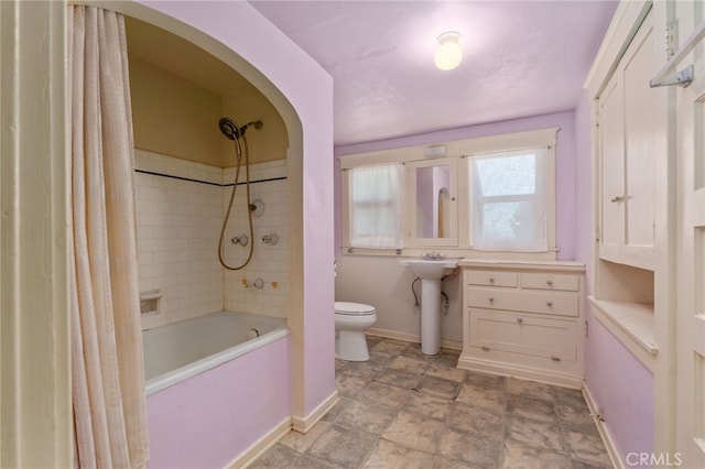 full bathroom featuring sink, toilet, and shower / tub combo with curtain