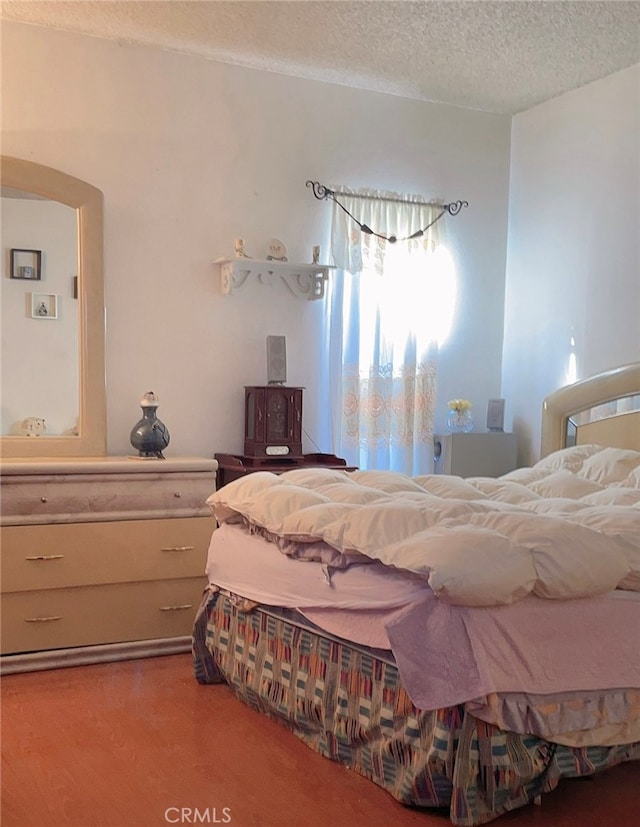 carpeted bedroom with a textured ceiling