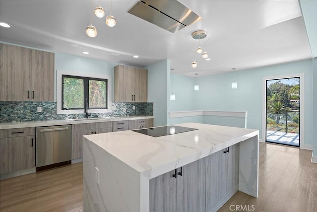 kitchen featuring dishwasher, a kitchen island, a healthy amount of sunlight, and black electric cooktop