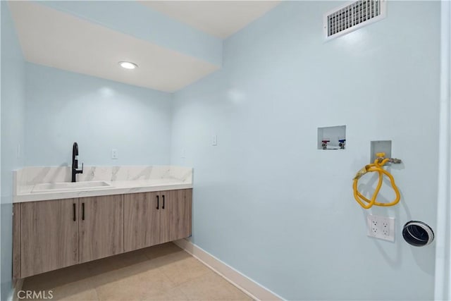 bathroom with tile patterned flooring and vanity