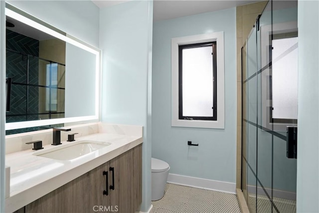 bathroom with tile patterned flooring, vanity, toilet, and tiled shower