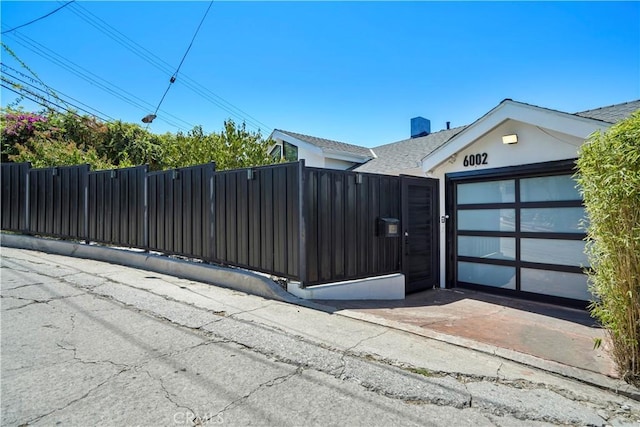 view of gate featuring a garage