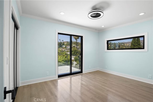 interior space featuring access to outside, light hardwood / wood-style flooring, and ornamental molding