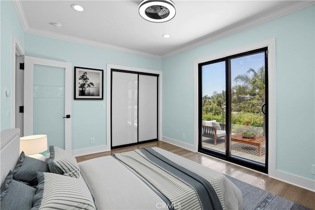 bedroom with access to exterior, hardwood / wood-style flooring, and ornamental molding