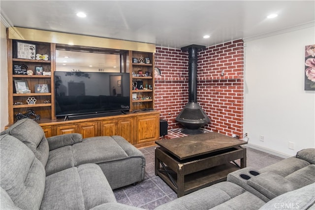 living room with ornamental molding and a wood stove