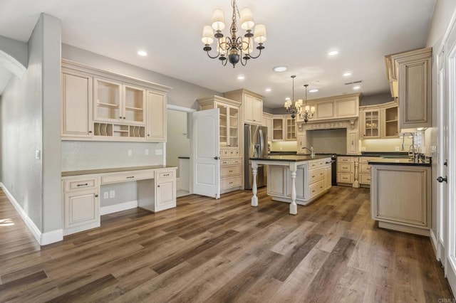 kitchen with a center island, dark hardwood / wood-style floors, stainless steel fridge, a chandelier, and pendant lighting