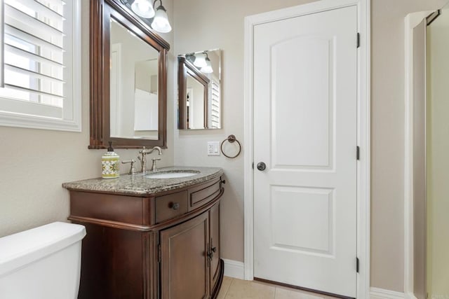 bathroom with tile patterned floors, vanity, and toilet