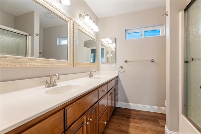 bathroom featuring hardwood / wood-style floors, vanity, and an enclosed shower