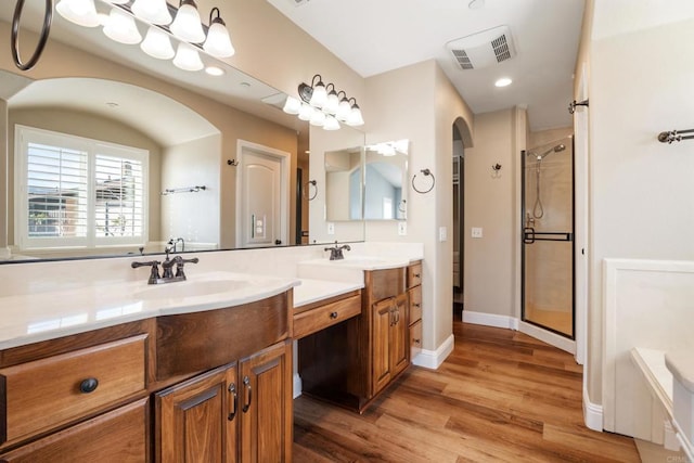 bathroom featuring hardwood / wood-style floors, vanity, and independent shower and bath