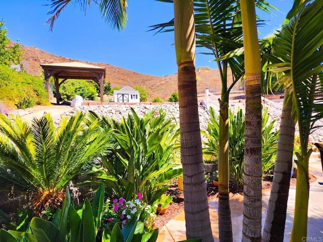 view of yard with a mountain view and a gazebo