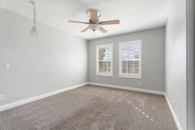 spare room featuring carpet and ceiling fan